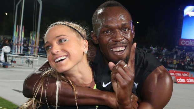 Usain Bolt hugs Australian Genevieve LaCaze as he celebrates winning the event during the Melbourne Nitro Athletics Series.