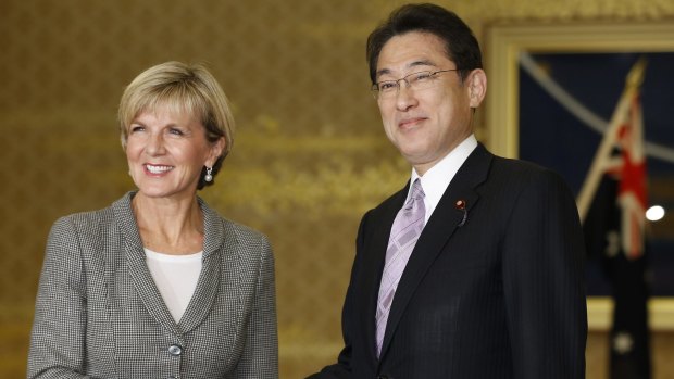 Australian Foreign Minister Julie Bishop, left, and her Japanese counterpart Fumio Kishida shake hands at the start of their meeting at Foreign Ministry's Iikura Guesthouse in Tokyo on Monday.
