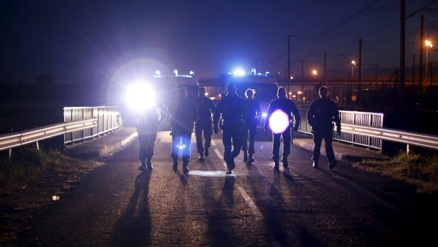 French police patrol access to the Channel Tunnel in Frethun, near Calais.