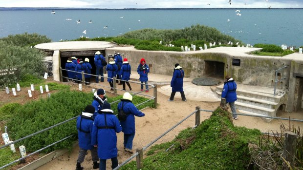 Visitors take a look at the bunkers at South Channel Fort.