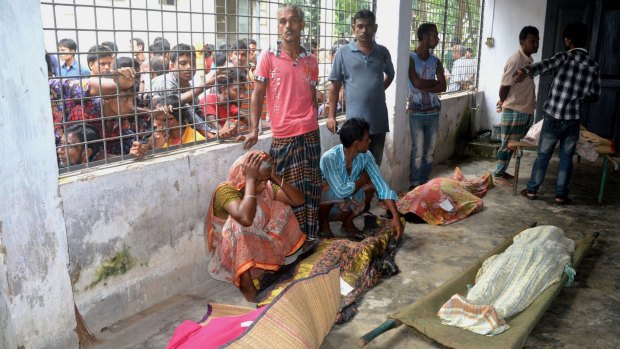 An elderly woman grieves next dead bodies at Mymensingh Medical College Hospital in the town of Mymensingh north of Dhaka, Bangladesh, on Friday.