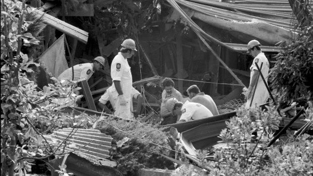 Police examine the remains of Richard Gee's Belrose house in 1984 after it was bombed.