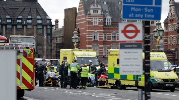 Emergency services staff provide medical attention close to the Houses of Parliament in London, after the attack on Wednesday.