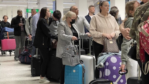 Passengers queue for check-in at Manchester Airport, which was also badly hit by staff shortages this month.