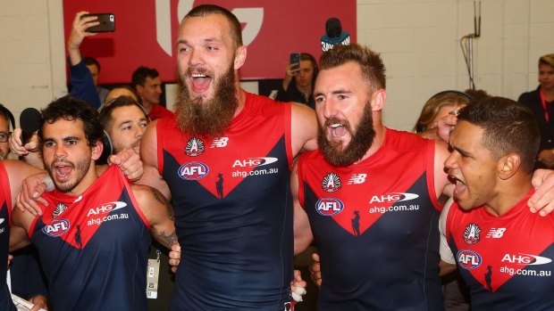 Jeff Garlett, Max Gawn, Lynden Dunn and Neville Jetta sing their club song in the rooms after defeating Richmond.