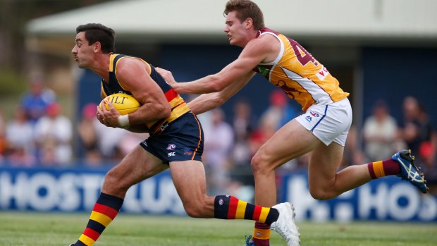 Crows captain Taylor Walker, marking in front of Lion Matthew Hammelmann in a pre-season match, is in a race to be fit for the round one opener. 