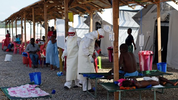 Nurses wear personal protective equipment while treating ebola patients at a treatment centre run by the Red Cross. 