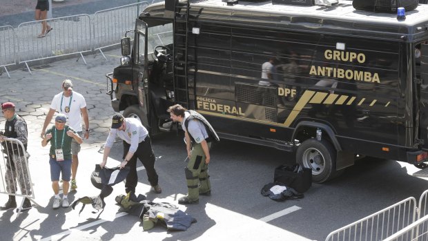 Members of Brazilian bomb squad pack their gear after detonating a suspicious package near the men's cycling road race final in Copacabana.