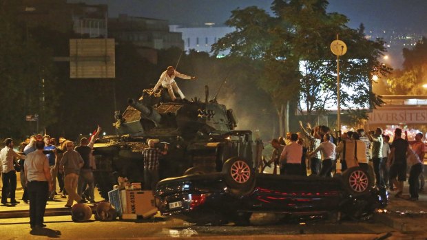 Tanks move into position as Turkish people attempt to stop them, in Ankara, Turkey, early on Saturday.