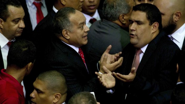 Diosdado Cabello, outgoing parliamentary president, centre left, argues with an opposition congressmen before leaving the National Assembly in Caracas, Venezuela, on Tuesday.