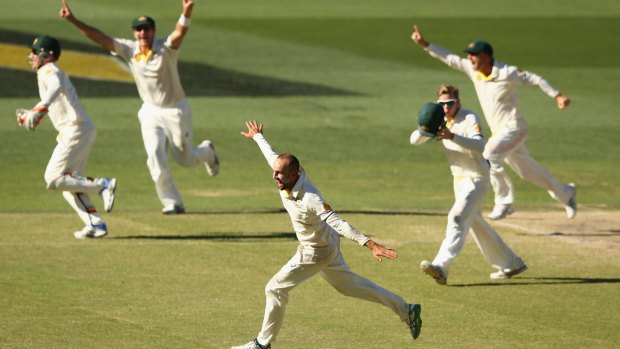 Nathan Lyon and teammates celebrate after he takes the wicket of Ishant Sharma to wrap up the Adelaide Test.