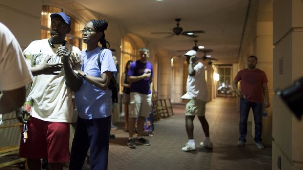 People concerned about relatives seek information from police nearby the scene of a shooting at the Emanuel AME Church in Charleston.