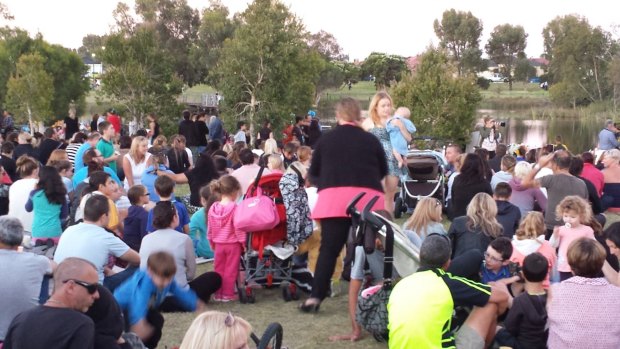 Hundreds gather at a Landsdale lake to pay tribute to two-year-old Sam Trott in 2014.