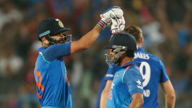 Composed: India's Kedar Jadhav, right celebrates his ton with captain Virat Kohli.