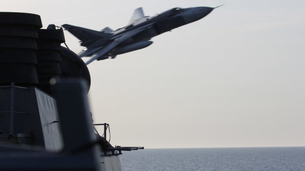 A Russian SU-24 jet makes a close-range and low altitude pass near the USS Donald Cook in 2016 in the Baltic Sea.