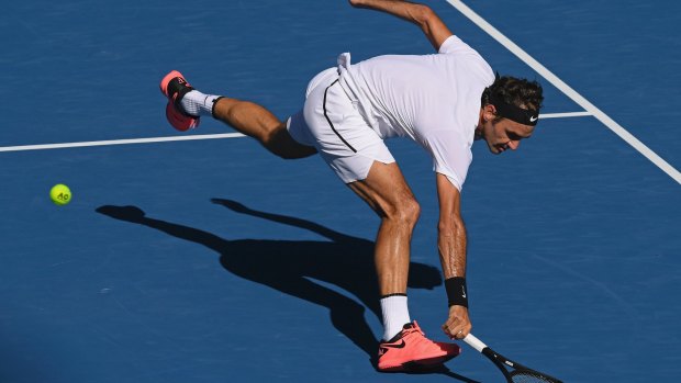 Roger Federer reaches for a backhand return to Hungary's Marton Fucsovics during their fourth round match.