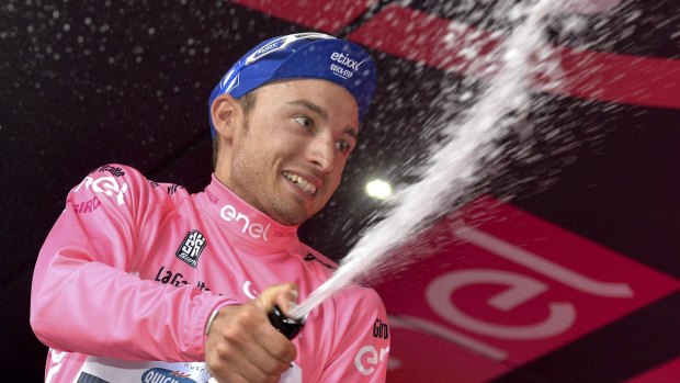 Pretty happy in pink: Italy's Gianluca Brambilla sprays sparkling wine on the podium after winning the eighth stage of the Giro d'Italia.