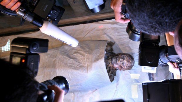 Photographers surround the mummy of Pharaoh Queen Hatshepsut at the Egyptian Museum in Cairo.