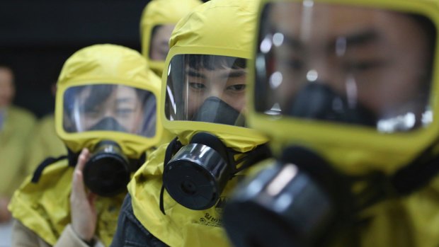 South Korean government officials wearing gas masks attend a civil defence drill against a possible North Korean chemical attack at their office in Seoul, South Korea, last week.