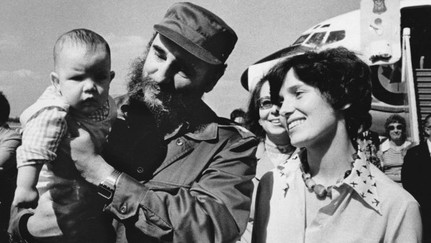 In this 1976 photo, Margaret Trudeau smiles as Cuban President Fidel Castro holds her youngest son Michel after the Trudeaus arrived in Havana, Cuba. 