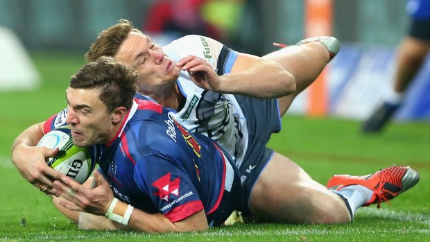 Cam Crawford of the Rebels is tackled by Dane Haylett-Petty of the Force  during the round 18 match on Friday.