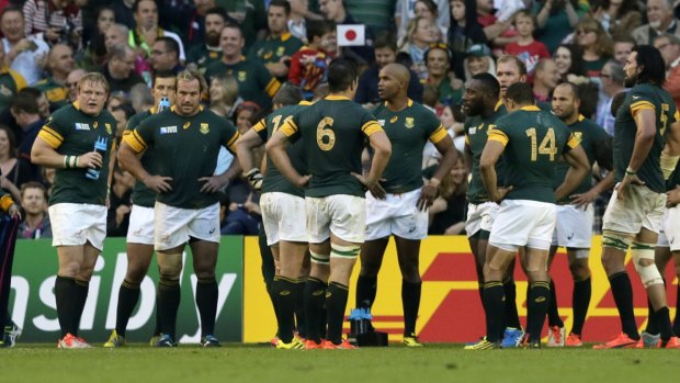 In deep: South Africa's stunned players after they were beaten by Japan.