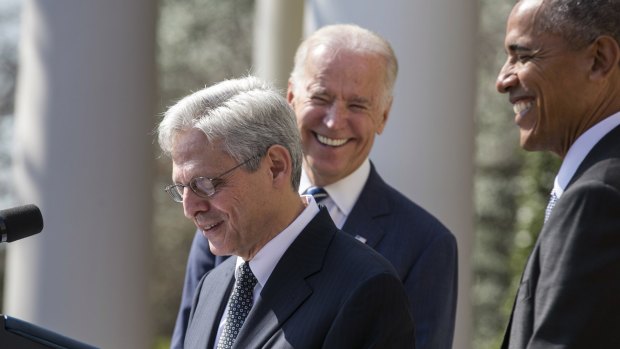 US President Barack Obama, right, and Vice President Joseph Biden, centre, laugh as Merrick Garland, chief judge of the US Court of Appeals for the District of Columbia Circuit, following the announcement of his nomination for the Supreme Court in the Rose Garden of the White House in Washington on Wednesday.