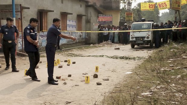 Members of Bangladesh's Police Bureau of Investigation (PBI) inspect the site where an Italian priest was attacked at Dinajpur, 415 kilometres north of the capital Dhaka.