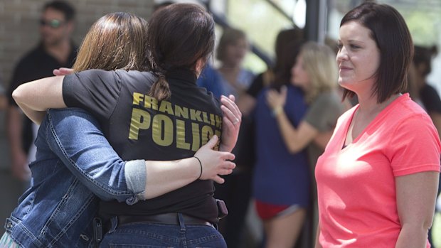 Franklyn police chief Sabria McGuire hugs Christian Wise as Britney Landry looks on outside a rosary service for Mayci Breaux in Franklin, Louisiana, on Friday.