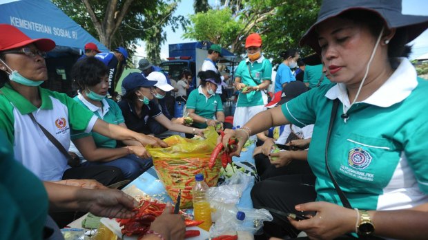 Food is prepared at an evacuee centre at Klungkung sport centre. 