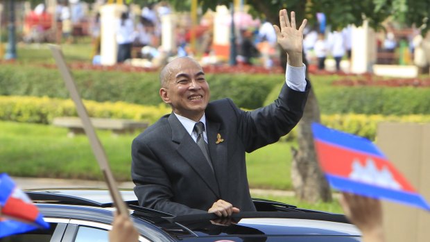 Cambodia's King Norodom Sihamoni waves to students during the Independence Day celebrations in Phnom Penh last week. 
