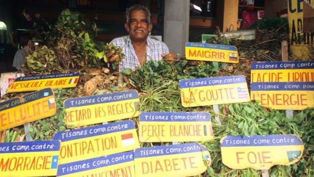 A herbal tea merchant sells his wares at Port Louis Central Marketplace.