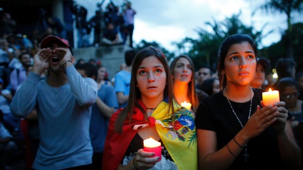 Anti-government demonstrators at a candlelight vigil last month in honour of those who have been killed during clashes between security forces and demonstrators in Venezuela's capital, Caracas. At least 125 people have died in street protests in the past four months.