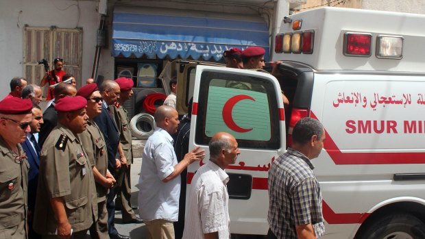 People follow the ambulance carrying the coffin of the head of the pediatric service at the Tunis military hospital, Colonel Fathi Bayoudh, one of the victims killed in Tuesday's blasts at the Istanbul airport.
