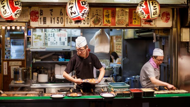 Traditional Japanese street food takoyaki in Osaka, Japan.