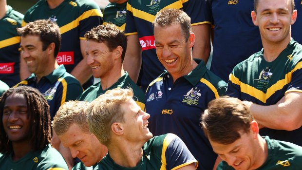Lining up: Head coach Alastair Clarkson jokes with Nick Reiwoldt during a team photo before a training session in Perth.