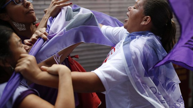 Anti-government demonstrators clash with a Rousseff supporter in Sao Paulo, on International Women's Day.
