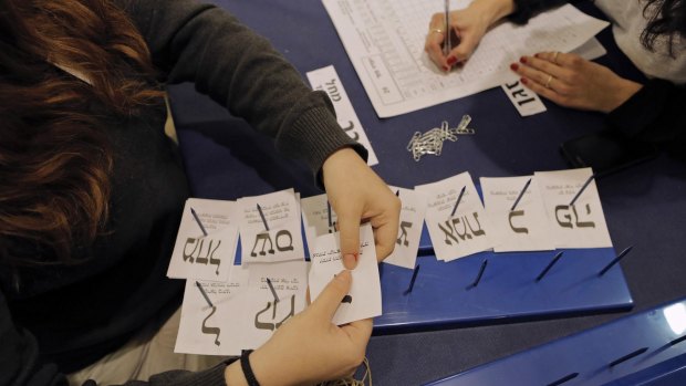 Ballots are counted at Israel's  central elections committee building in the Knesset on March 18. Mr Netanyahu has gained enough cross-party support to form a governing coalition.