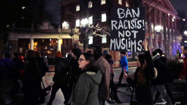 Several hundred people march through Harvard University while protesting against the travel ban. 