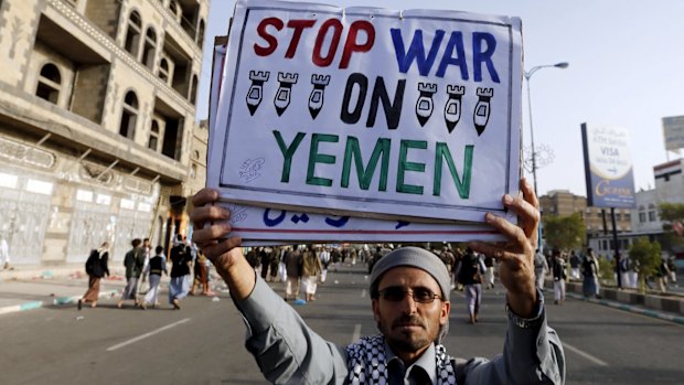 A follower of the Houthi group holds up a sign at the site of a demonstration against the air strikes by the Saudi-led coalition in Sanaa on April 27.