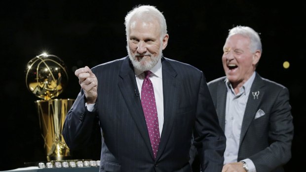 Lord of the rings: Gregg Popovich shares a laugh with Spurs owner Peter Holt at the team's championship ceremony on Tuesday.
