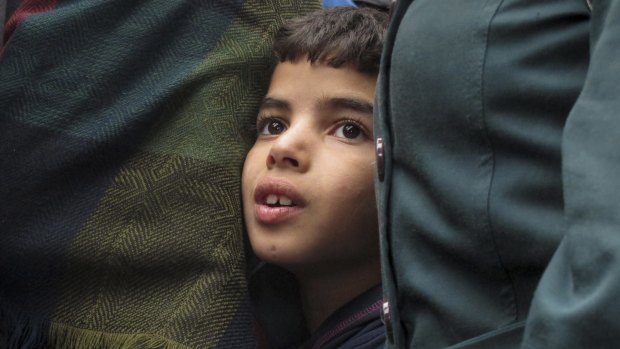 Laith Egbari, 7, from Aleppo in Syria waits to board a train at Keleti station in Budapest last week.