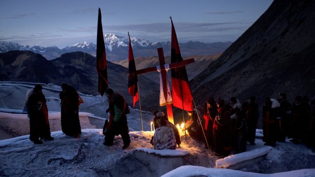 Ukukus – men dressed as mythical half-man, half-bear creatures – light candles on the glacier of the Qullqipunqu mountain, as part of the syncretic three-day festival Qoyllur Riti in Peru's Cusco region.