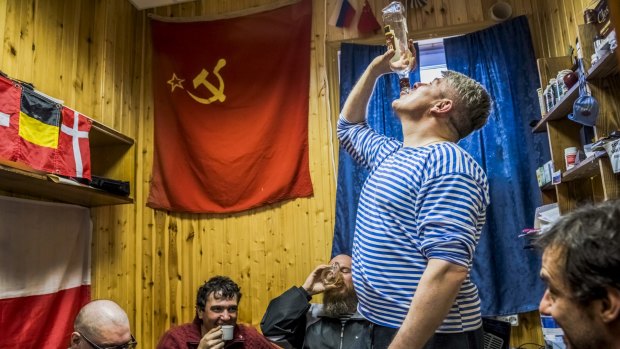 Chilean scientist Ernesto Molina (right) and Russian researchers drink homemade vodka at the Bellingshausen Antarctic base.