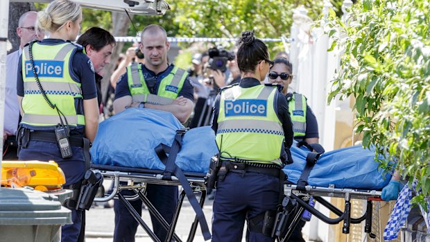 A dead body is removed from one of the squatters' houses.