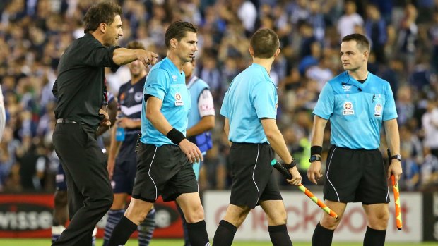 Referees could do with some help: Wanderers coach Tony Popovic has a word to the match officials as they leave the field after a match last season.