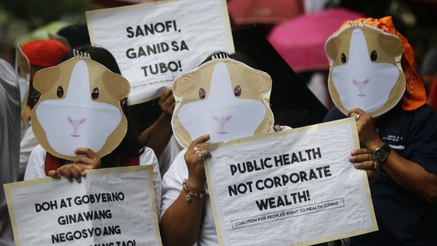 Protesters wear Guinea Pig masks to condemn the controversial mass immunisation of Filipino children with Dengvaxia.