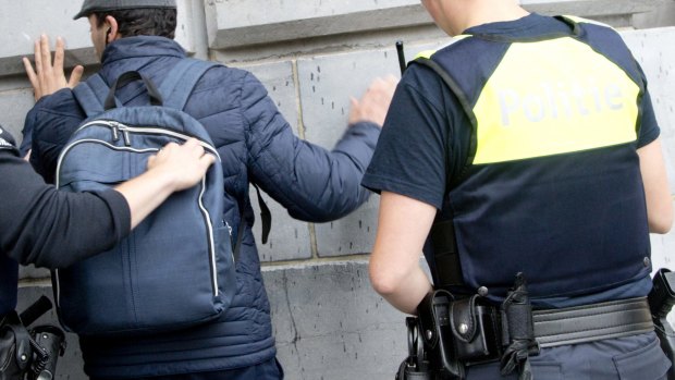 Police officers search a backpack at Antwerp Central train station in Antwerp, Belgium on Saturday.