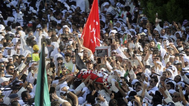 Thousands of Sunnis and Shiites from across the country take part in a mass funeral procession on Saturday for 27 people killed in a suicide bombing at the Shiite Imam Sadiq Mosque.