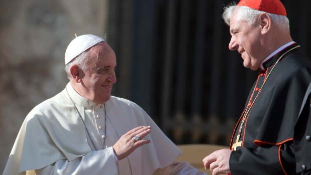 At odds: Pope Francis with Cardinal Gerhard Ludwig Mueller at the Vatican in 2014.